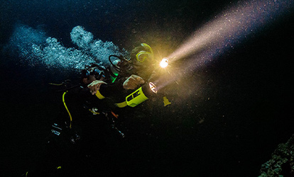 A person diving at night.
